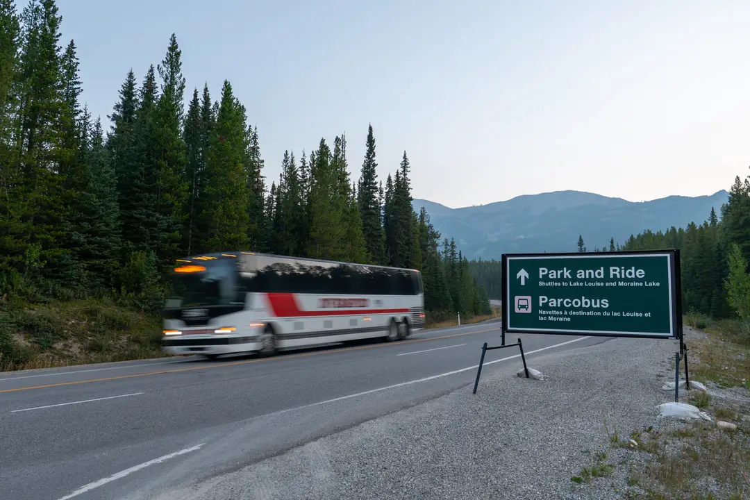 A shuttle departs the Lake Louise Park and Ride at the ski resort, bound for Lake Louise and Moraine Lake.