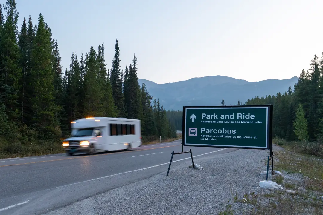 A shuttle departs the Lake Louise Park and Ride at the ski resort, bound for Lake Louise and Moraine Lake.
