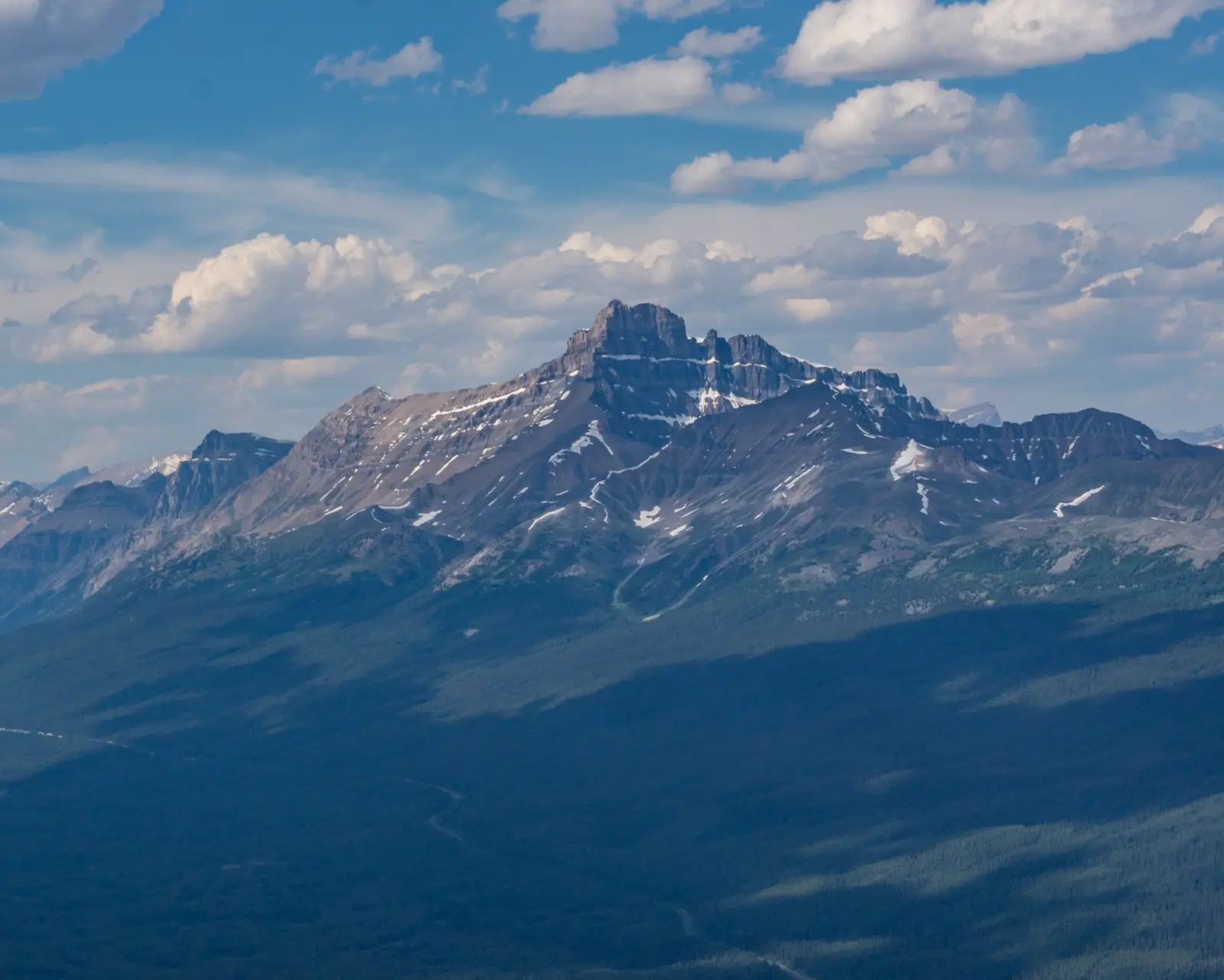 Mount Hector rising above the Icefields Parkway with the road winding below.