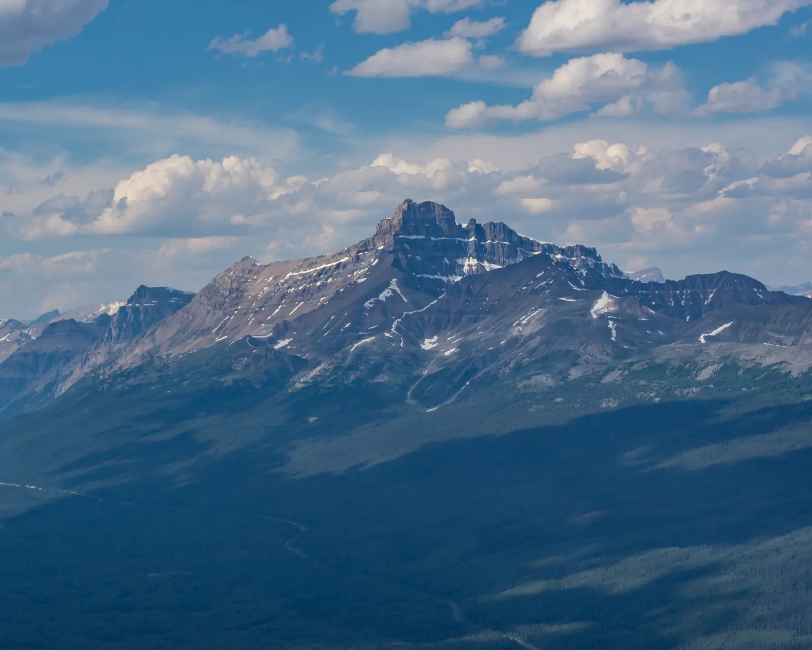 Mount Hector rising above the Icefields Parkway with the road winding below.